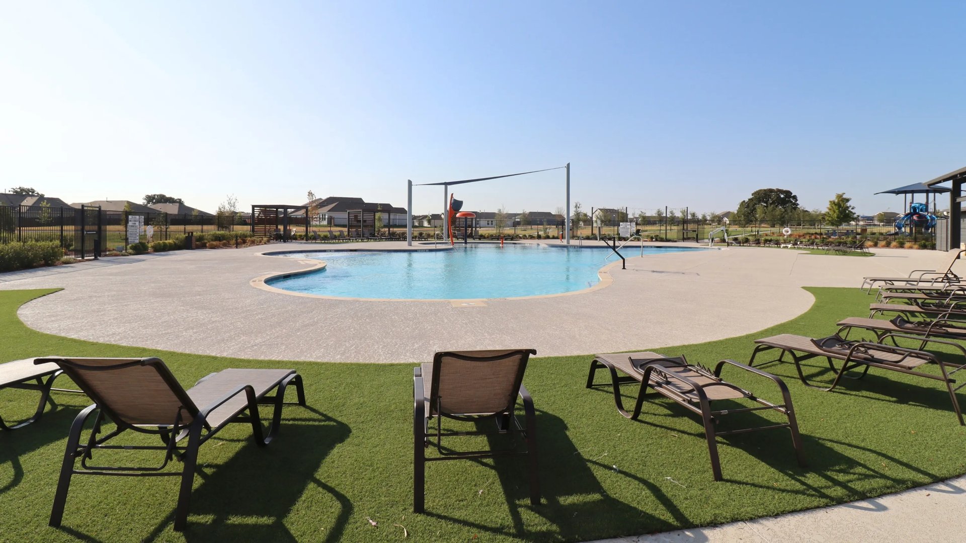 Wide view of lounge chairs and pool (Swimming Pool in Foree Ranch)