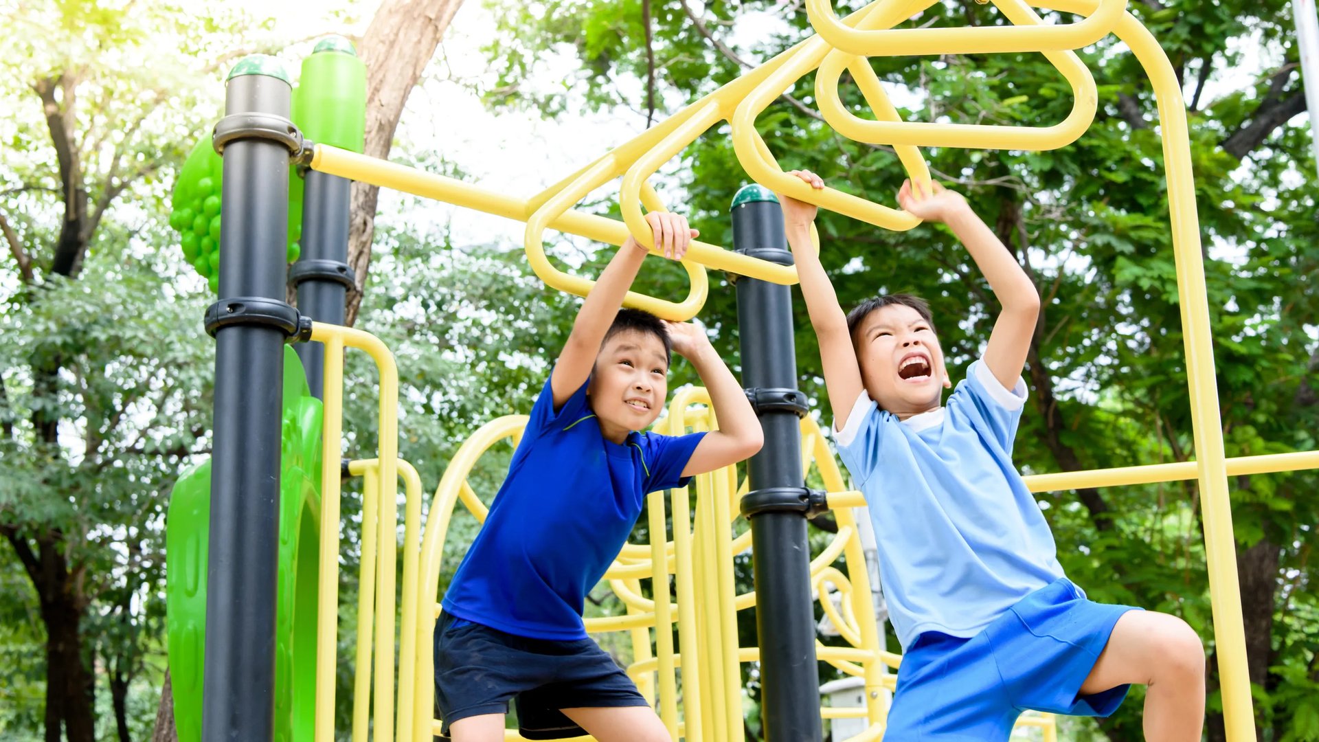 Two boys swinging on monkey bars (Playground in Daybreak)
