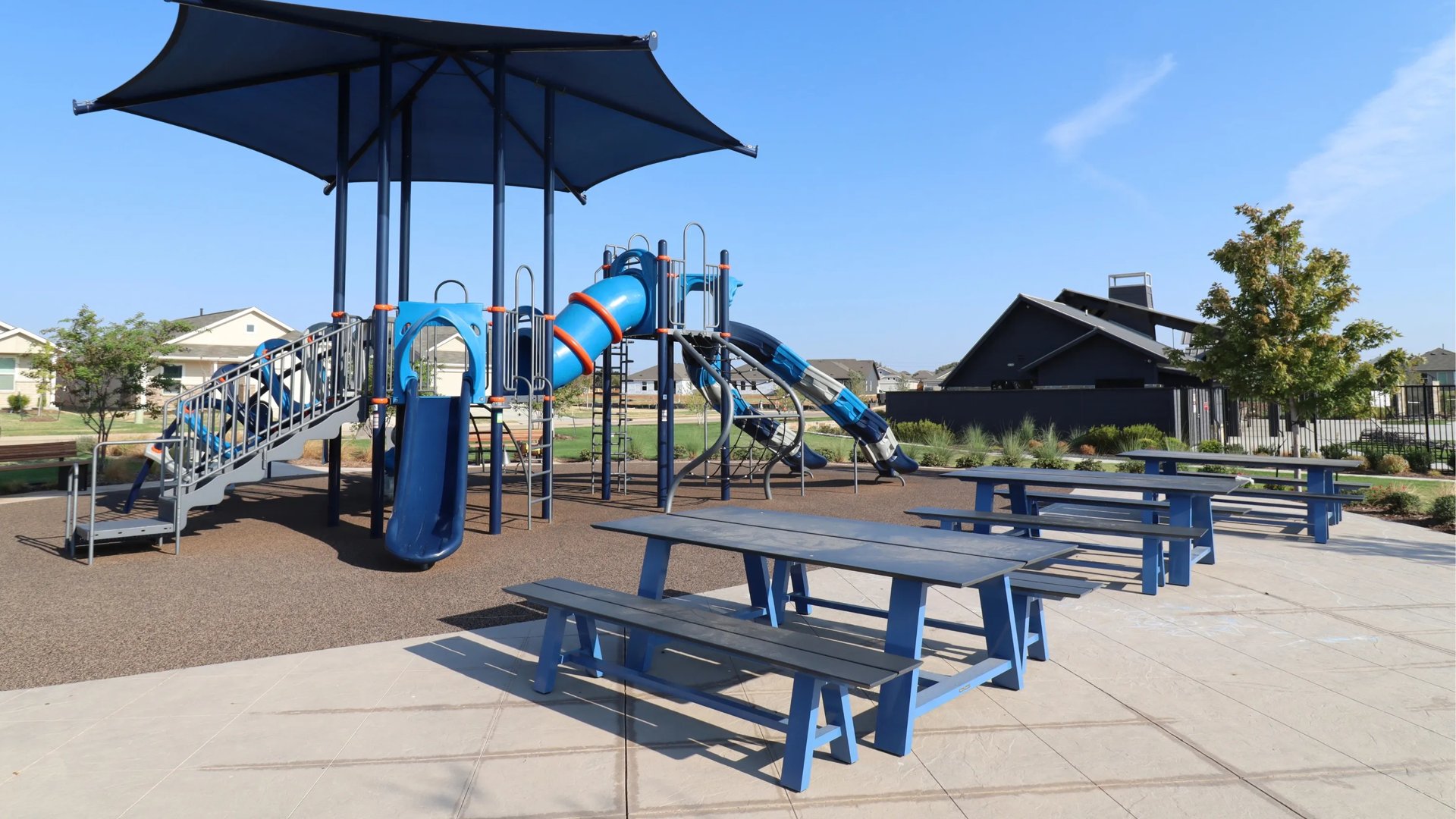 Blue playground and picnic tables (Playground in Foree Ranch)